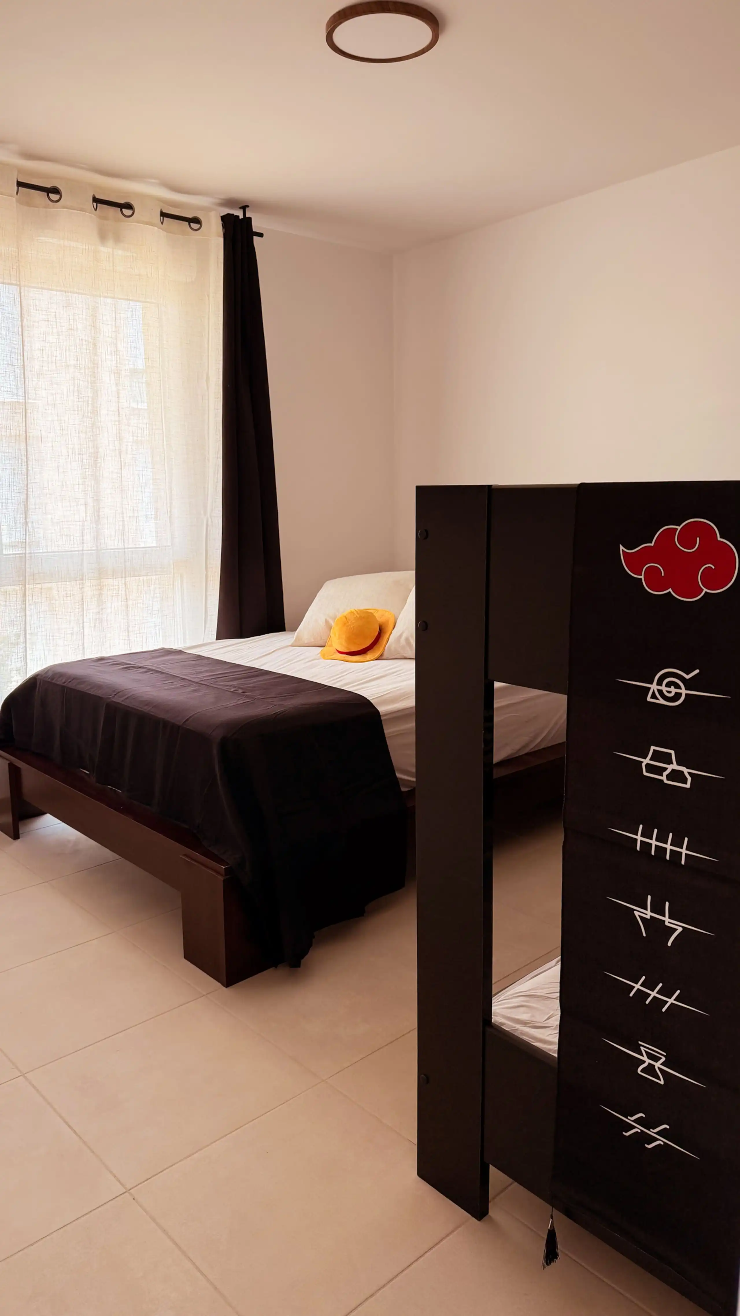 The bedroom at Nakama House with a double bed and a bunk bed, decorated in a manga world — photo 1