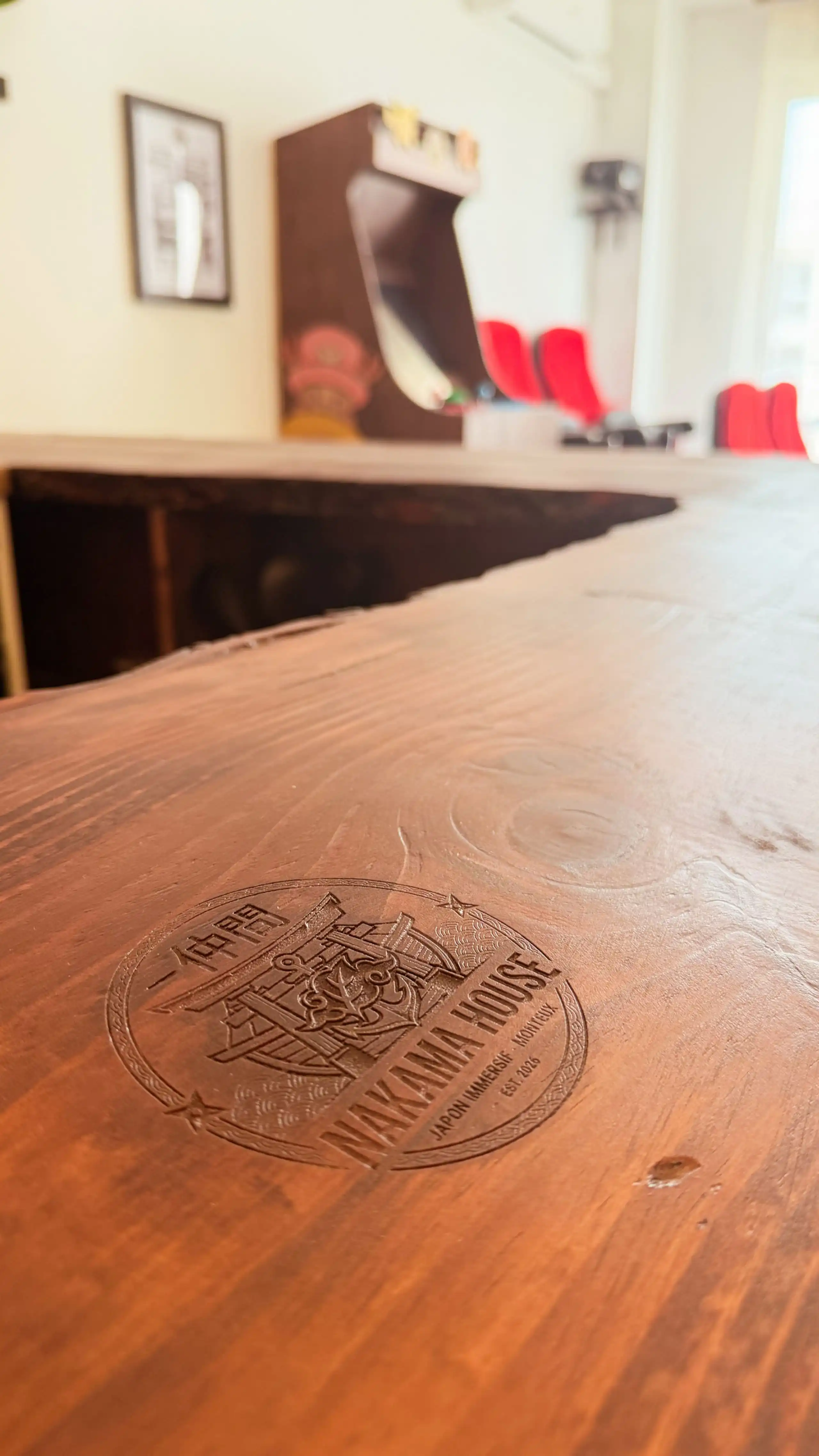 The dining space at Nakama House with bar stools along the wooden counter — photo 1
